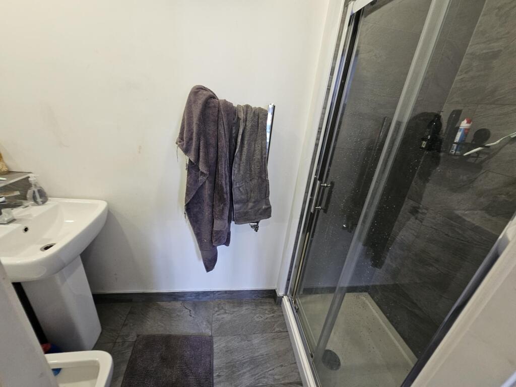 A clean and well-maintained bathroom with a sho...