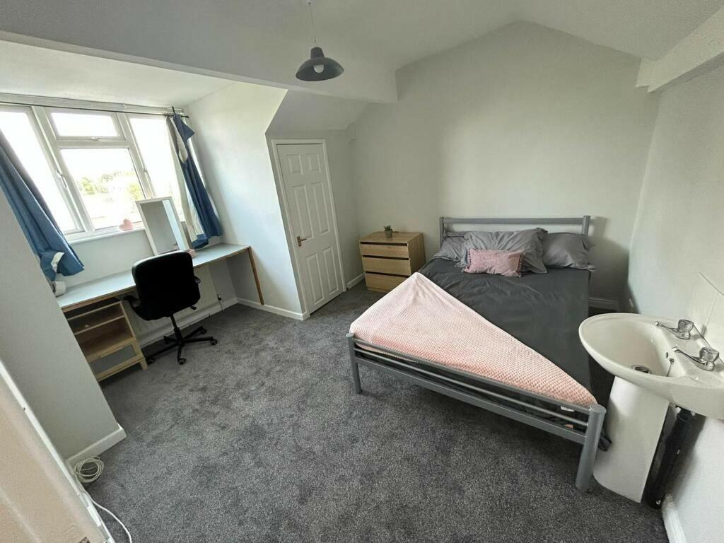 Bright and tidy double bedroom featuring a comf...
