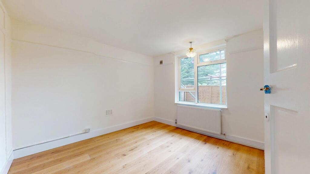 Bright and spacious living area with large wind...
