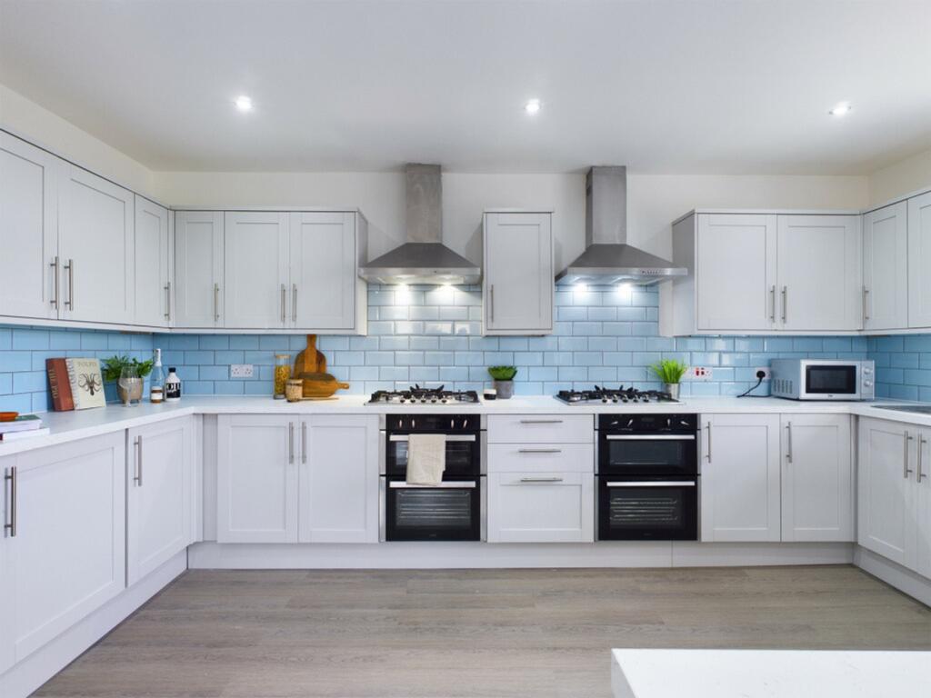 A modern and spacious kitchen featuring sleek c...