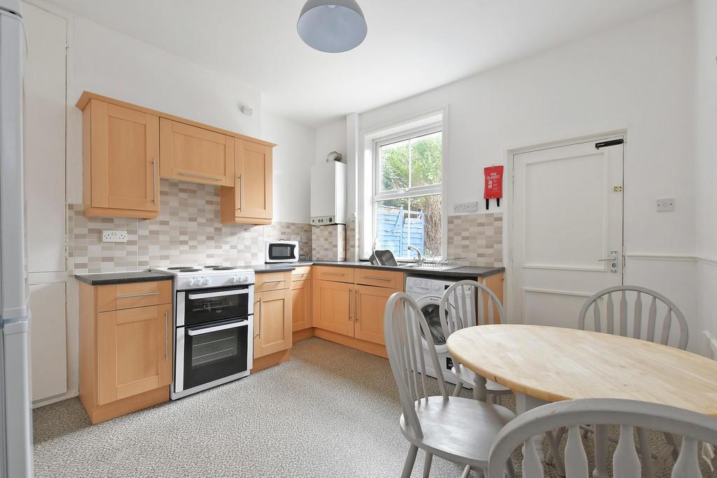 A bright and clean kitchen space featuring ligh...
