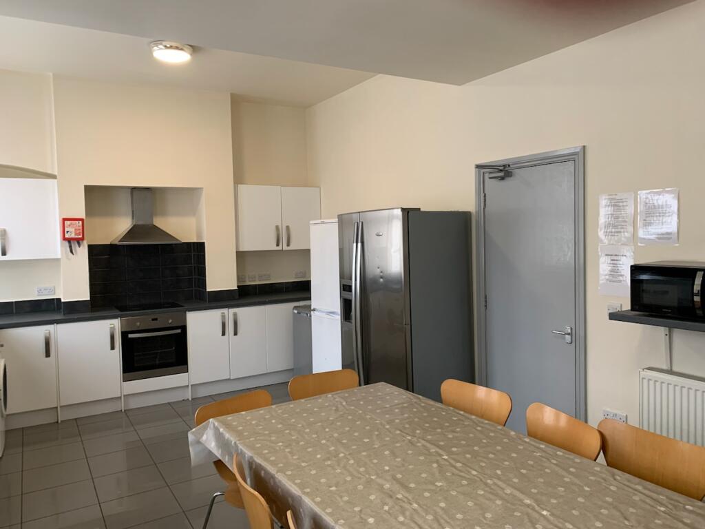 A spacious and well-lit kitchen area, perfect f...