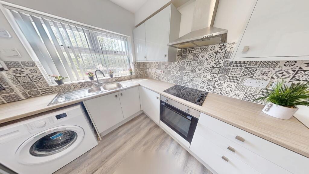 Bright and modern kitchen featuring stylish pat...