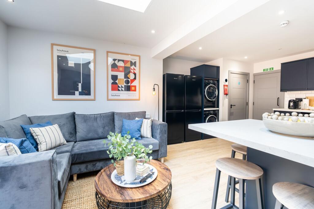 Bright and modern living area featuring a comfo...