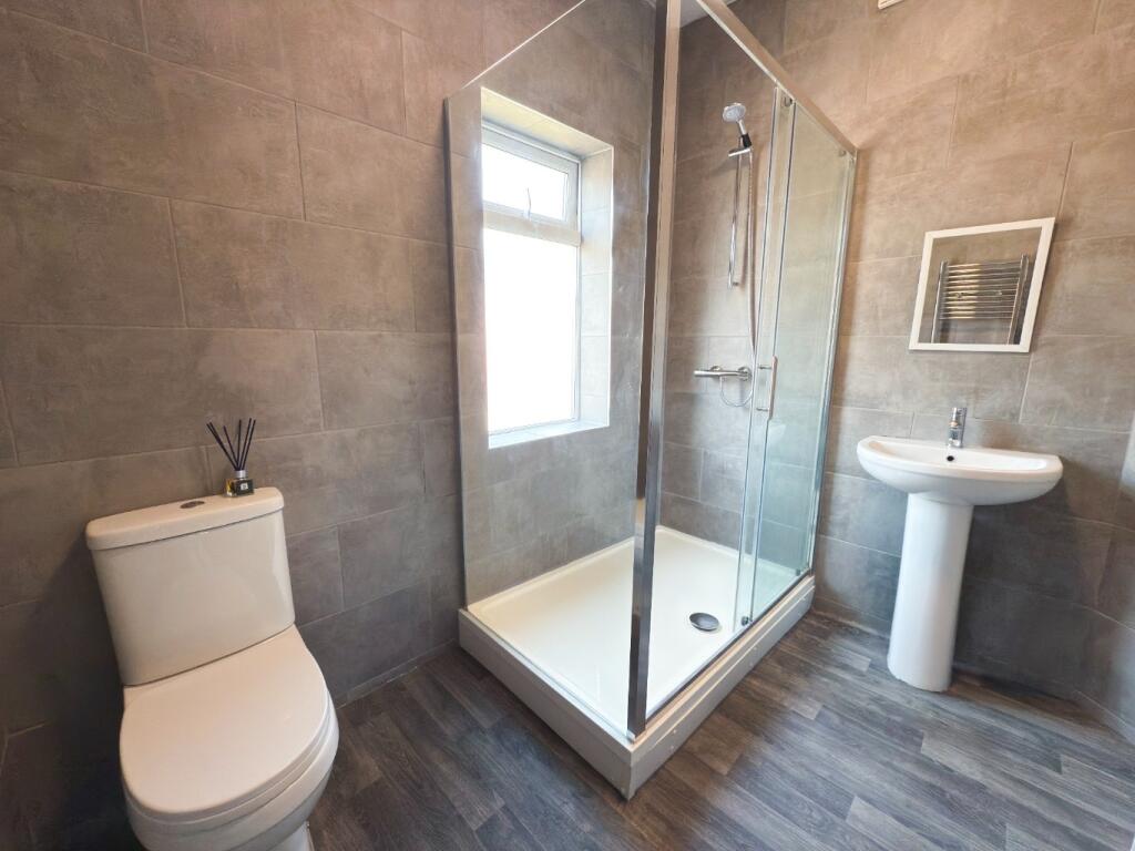 Contemporary bathroom with a framed glass showe...