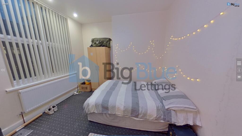 A cozy single bedroom featuring a neatly made b...