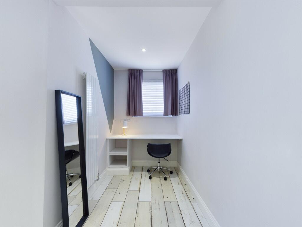 A small, clean bathroom featuring a modern toil...