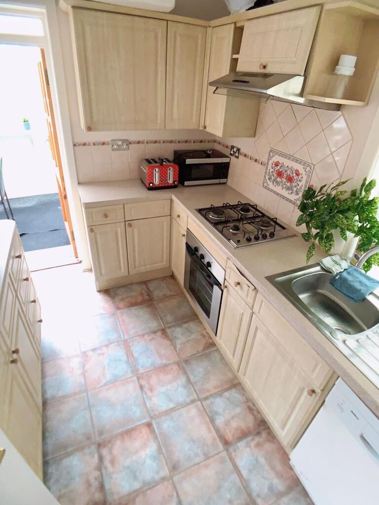 Bright and well-maintained kitchen with ample s...