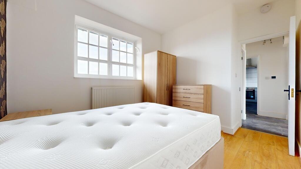 A bright and tidy double bedroom featuring a la...