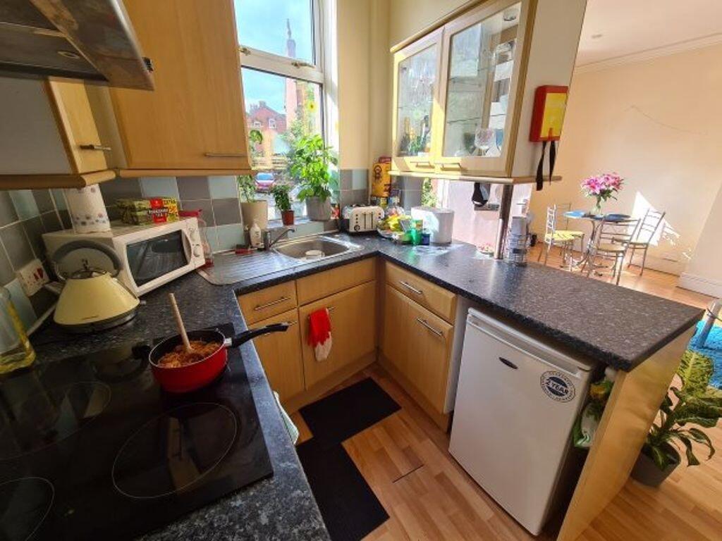 A bright and tidy kitchen with ample counter sp...