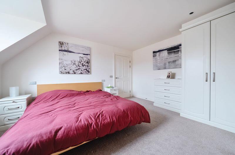 Bedroom with fitted wardrobes and ens...