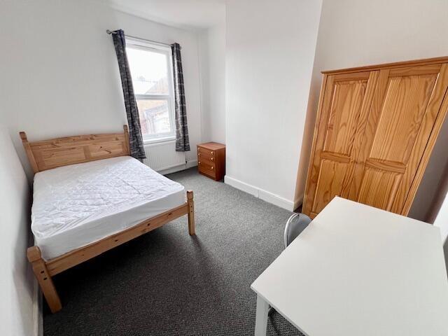 Bright and tidy double bedroom featuring a comf...