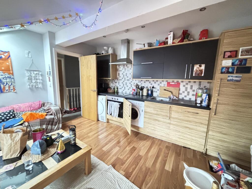 A spacious, modern living room with ample natur...
