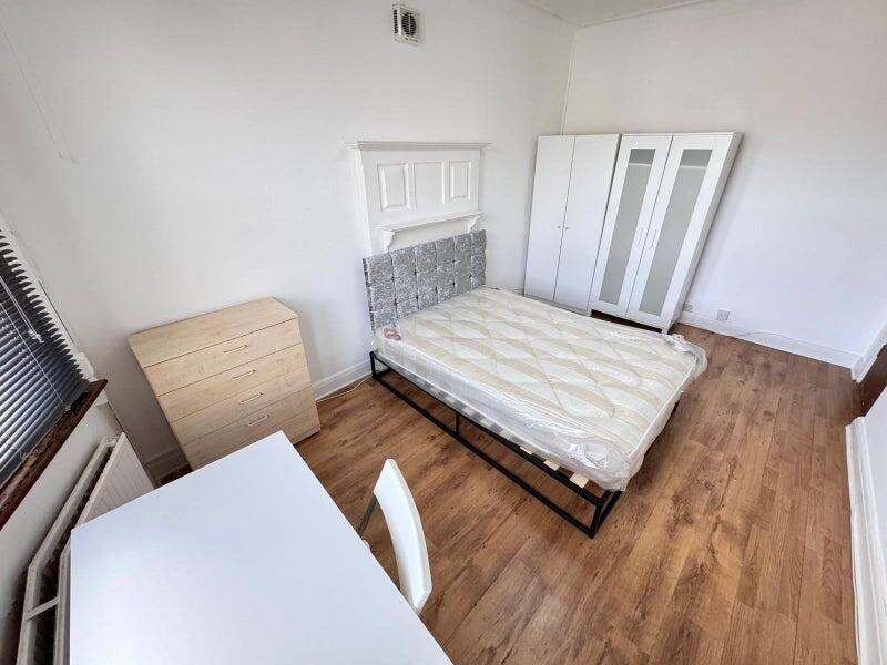 Bright and tidy double bedroom featuring a comf...