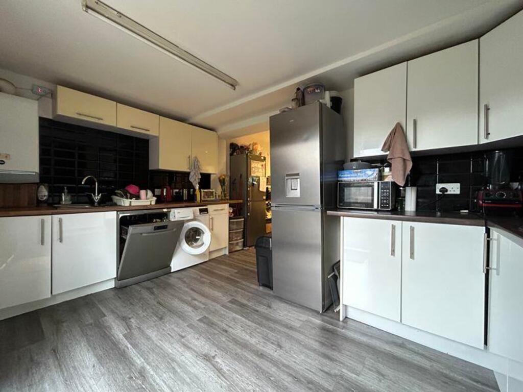 A spacious and modern kitchenette equipped with...