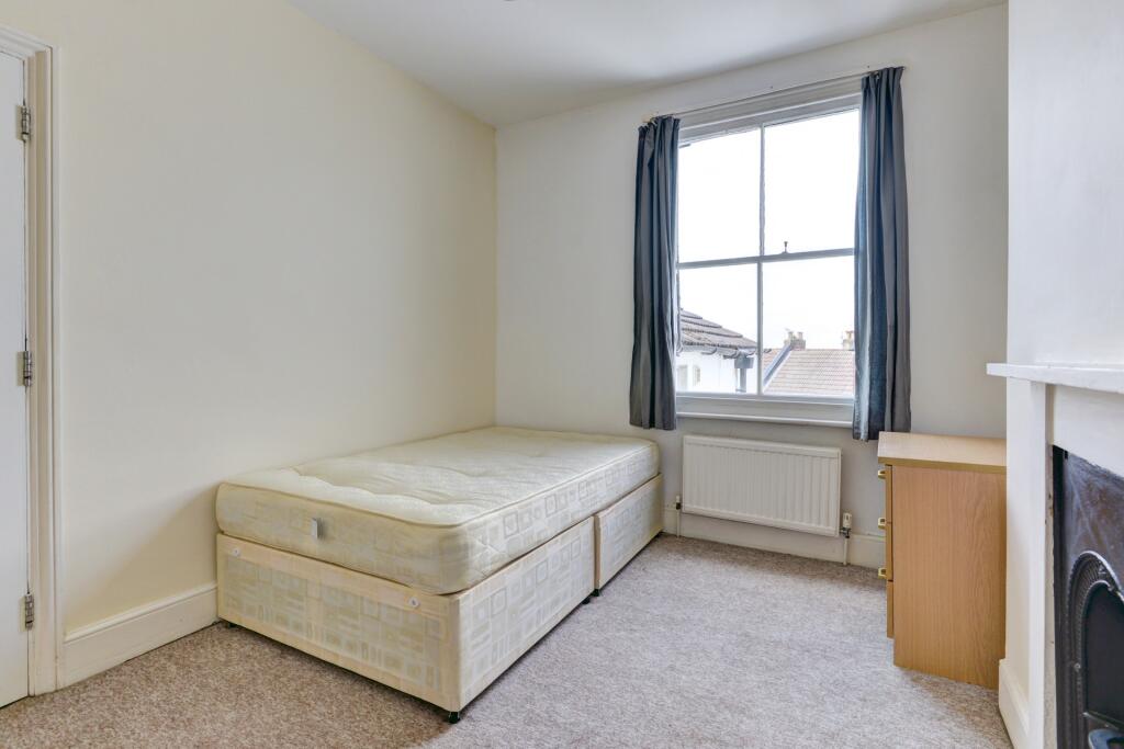 A bright and tidy single bedroom featuring a la...