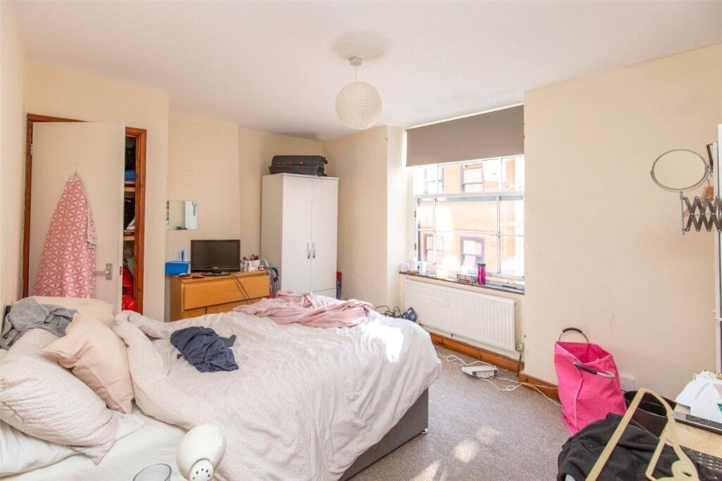 A bright, spacious double bedroom featuring a l...