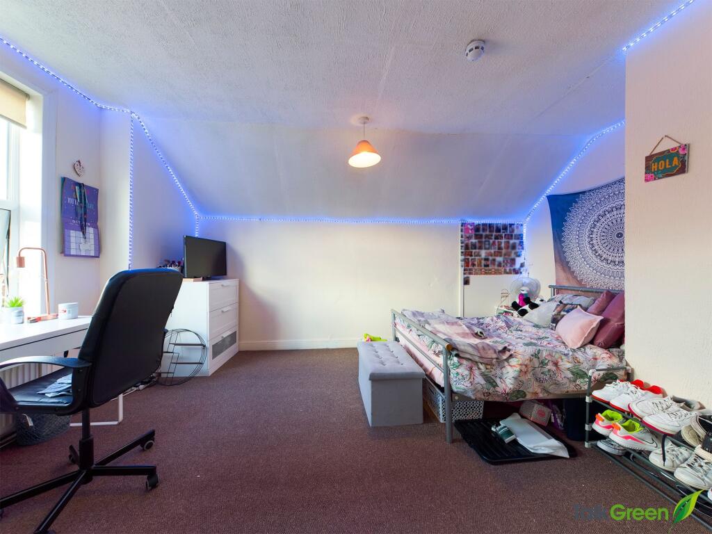 A bright and cozy bedroom with a comfy bed, a s...