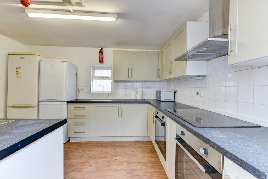 Bright and modern kitchen featuring ample count...
