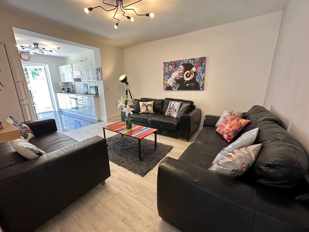 A stylish living room featuring comfortable bla...