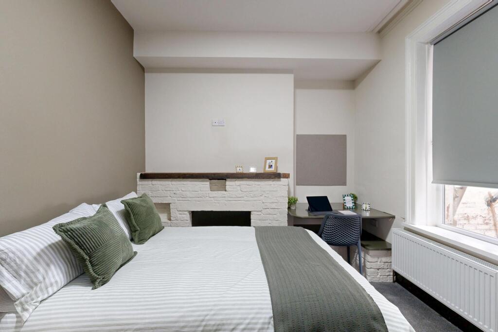 A well-maintained bedroom featuring a comfortab...