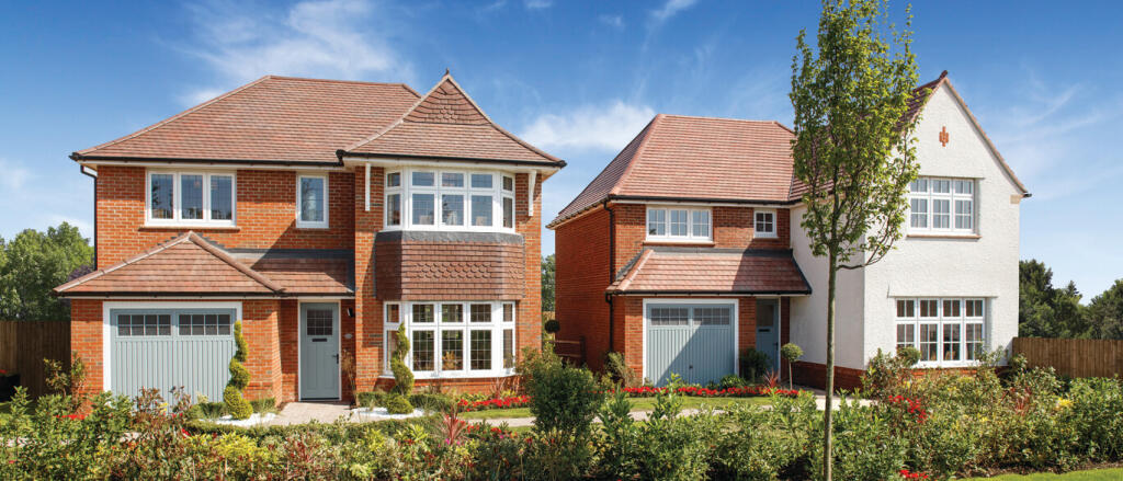 Two modern semi-detached houses with red brick and white exterior, surrounded by a well-maintained g