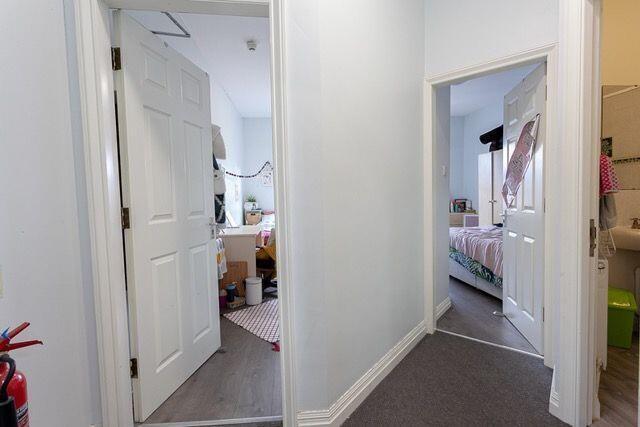 Bright and clean hallway with neutral decor and...