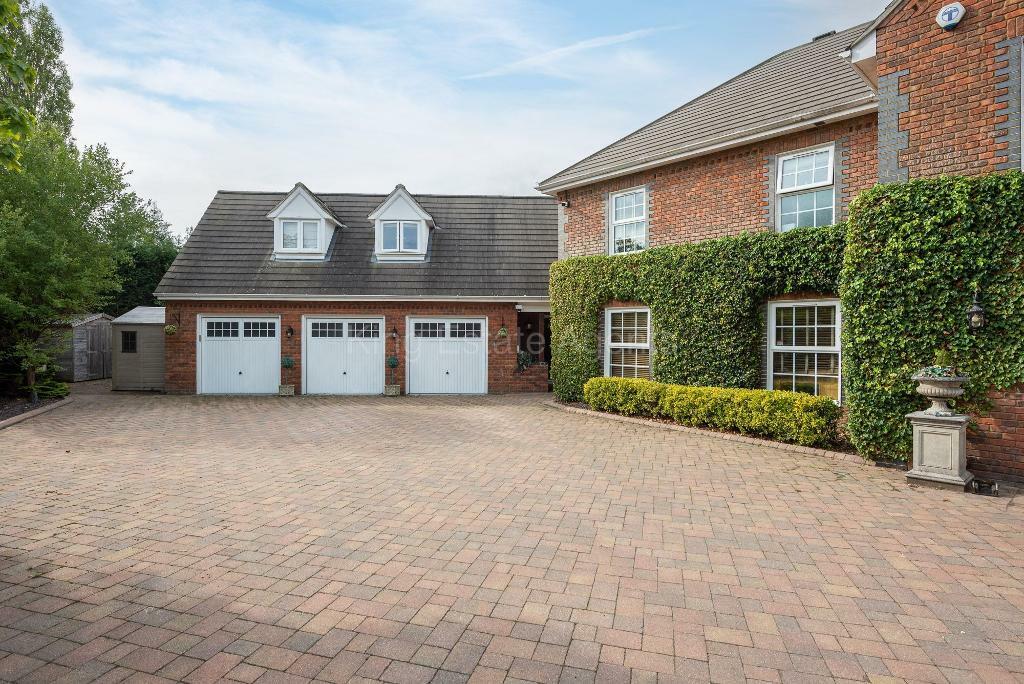 Front and triple garage with driveway