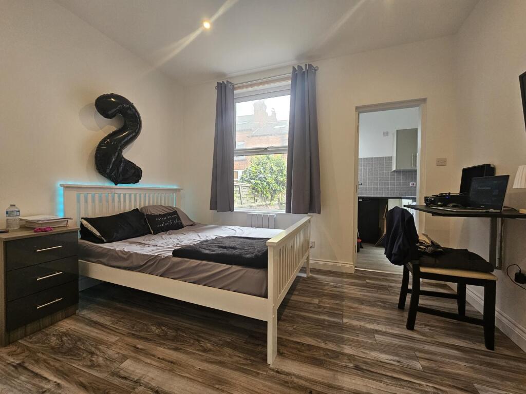 A bright and tidy double bedroom featuring a wh...