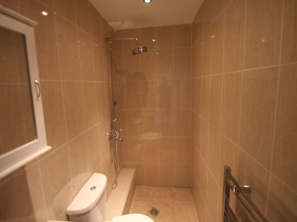 Contemporary tiled bathroom with a walk-in show...