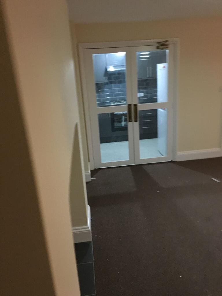 Carpeted interior hallway with double glazed gl...