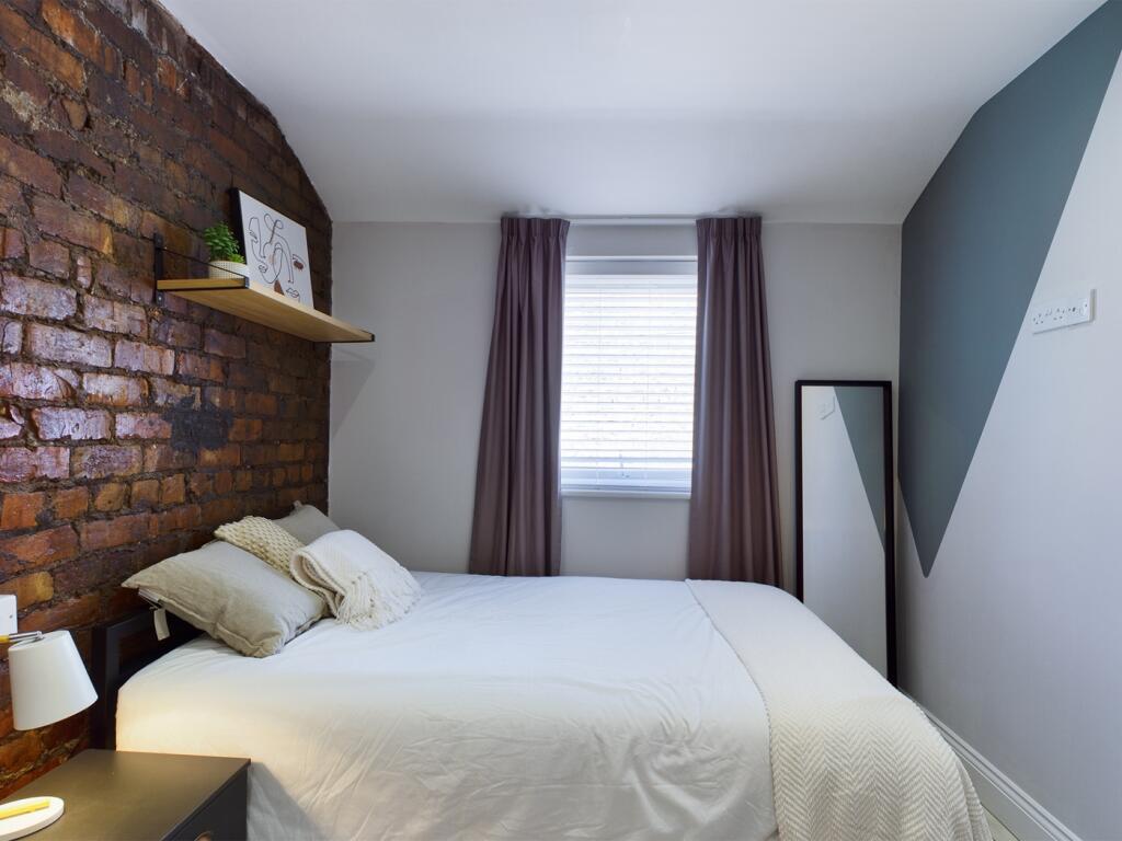 A stylish and inviting double bedroom featuring...