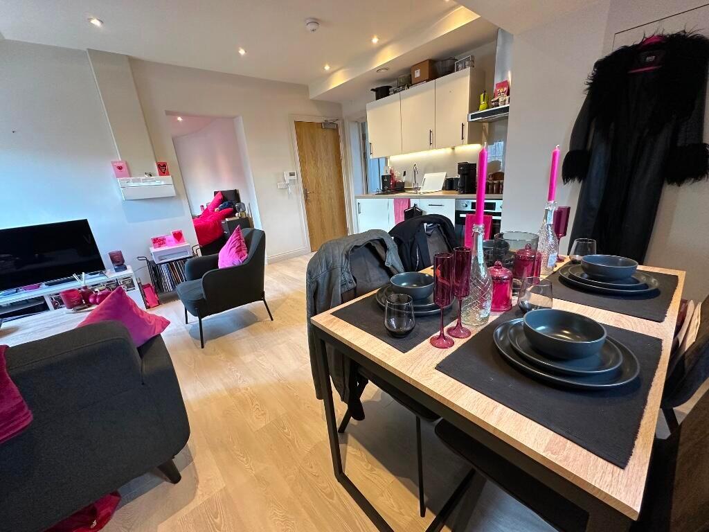 A modern living room featuring a stylish dining...