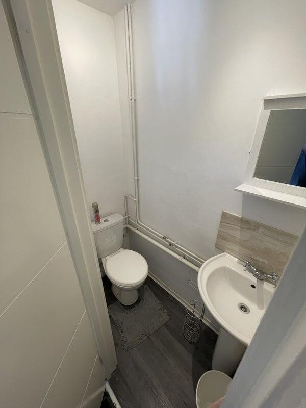 Compact and clean single toilet room with moder...