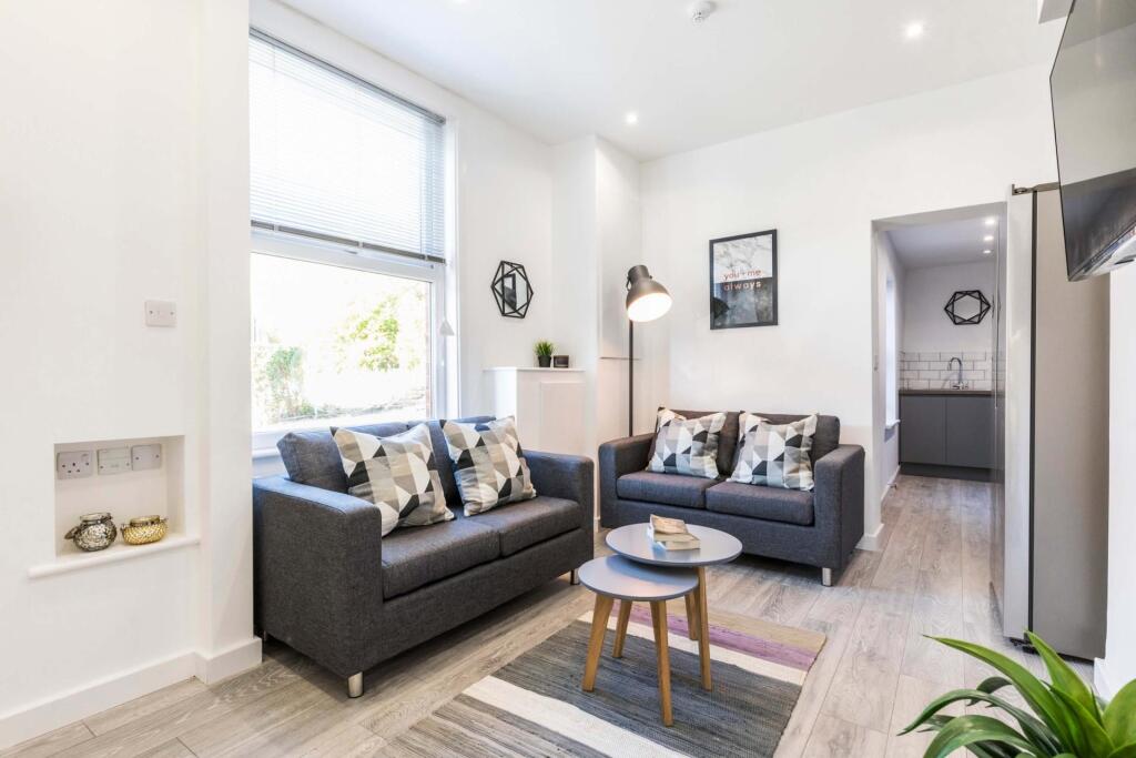 A modern, bright living room with large windows...