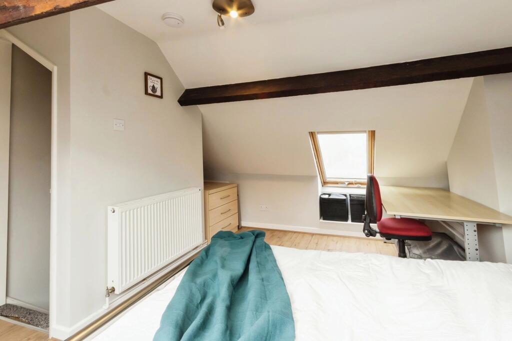 Bright and cozy bedroom with a comfortable bed,...