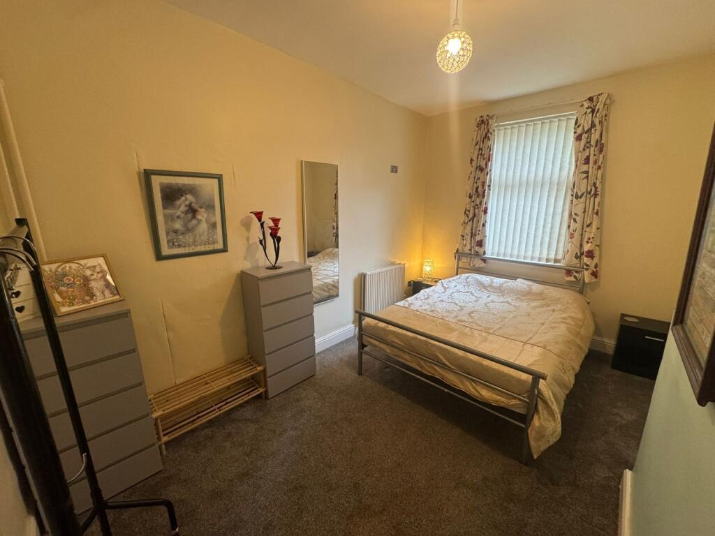 Cozy double bedroom featuring a comfortable bed...