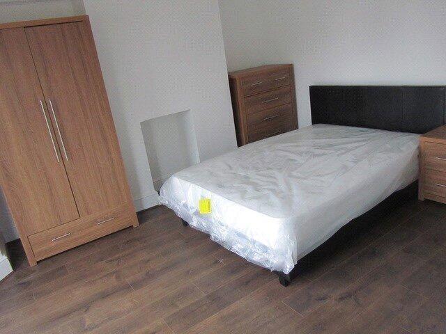 A neat and simple single bedroom featuring a wo...