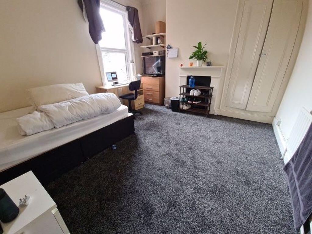 A welcoming and tidy living room featuring a co...