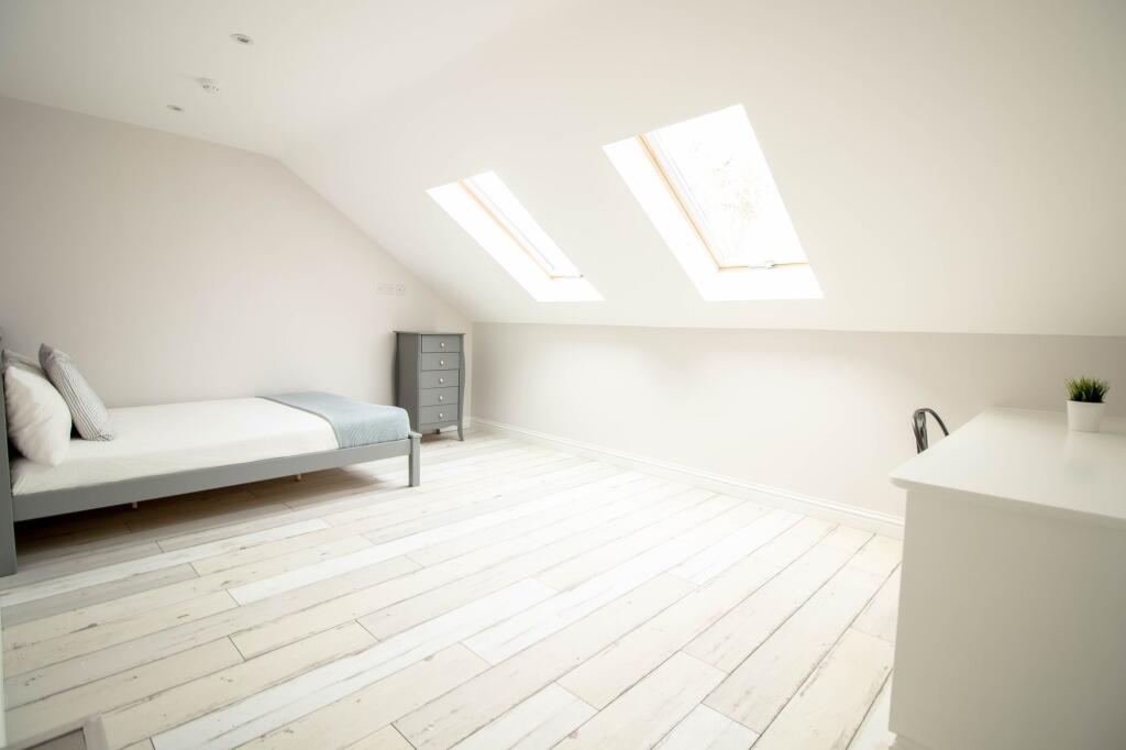 Bright and airy spacious master bedroom with la...
