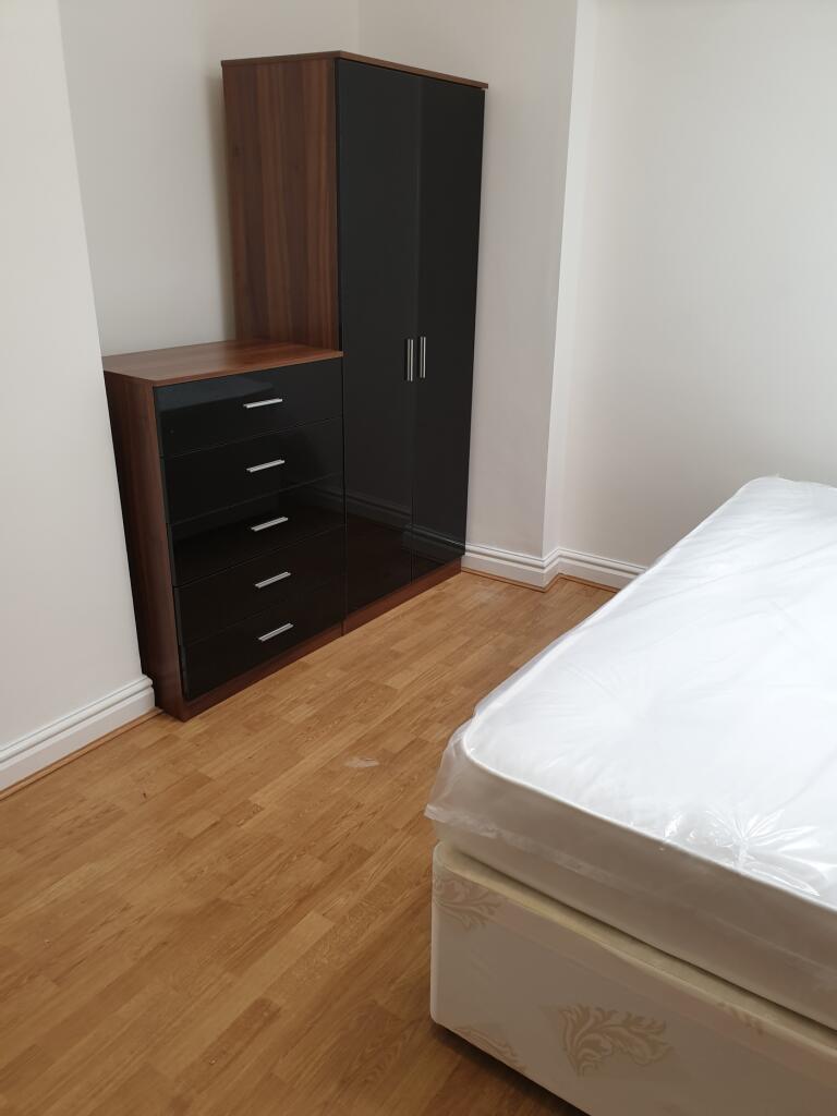 A bright and spacious double bedroom featuring ...