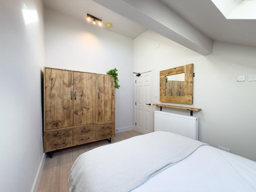 Bright, neatly presented bedroom with a comfort...