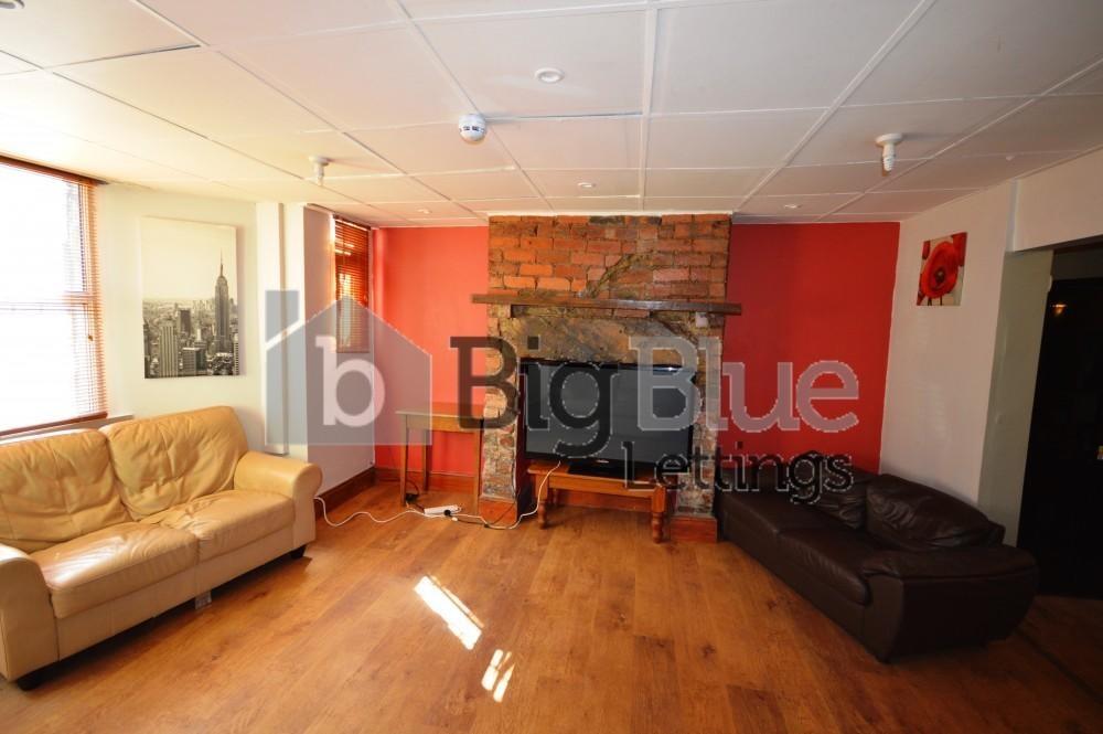 A warm and inviting living room featuring polis...