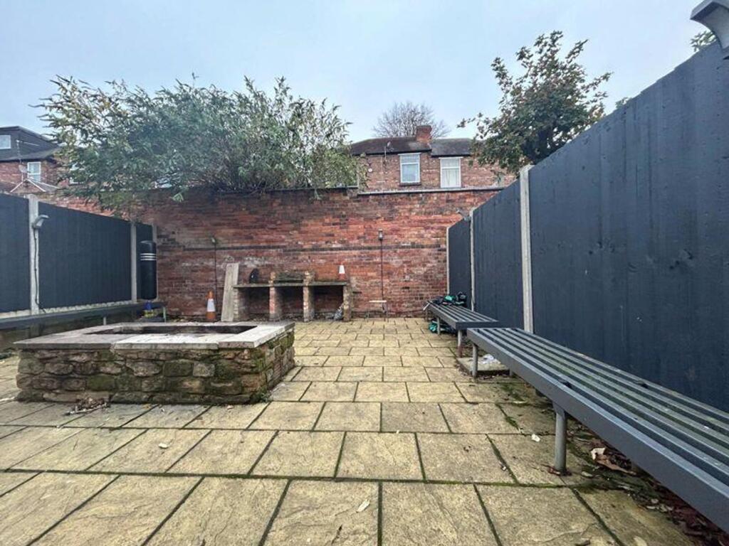 A spacious garden area with stone paving, perfe...