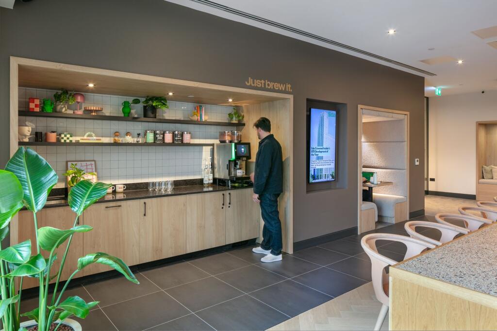 A modern communal lounge area featuring a styli...