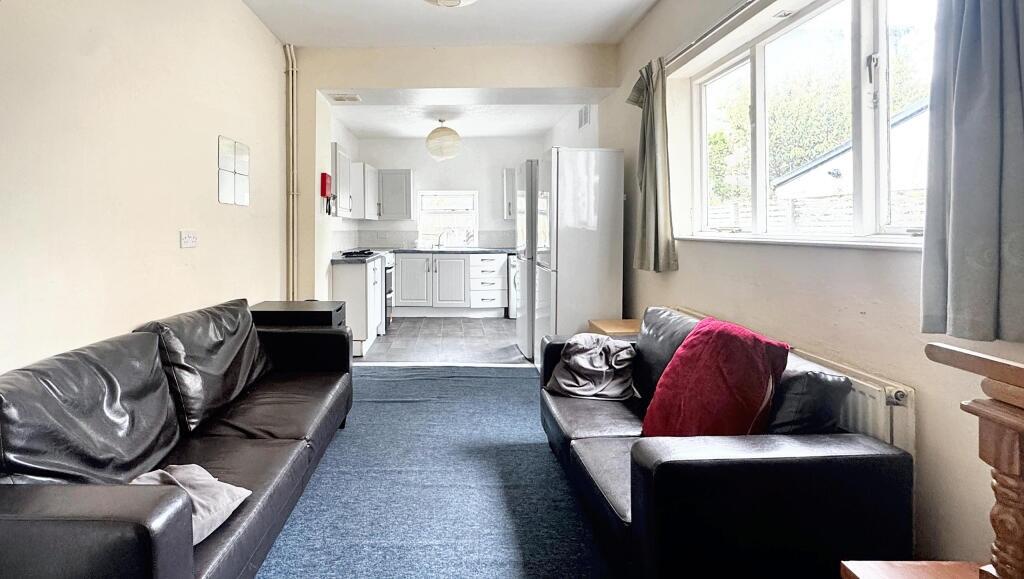 Bright and inviting living room with large wind...