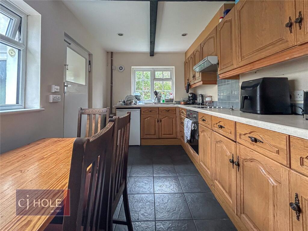 Bright and inviting kitchen featuring natural l...