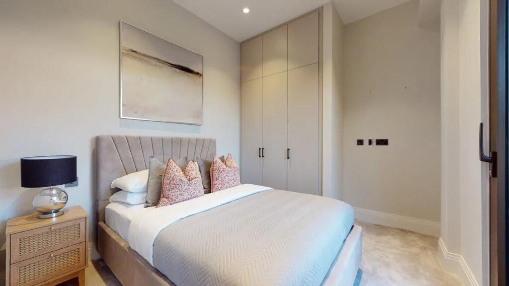 A stylish double bedroom featuring a comfortabl...