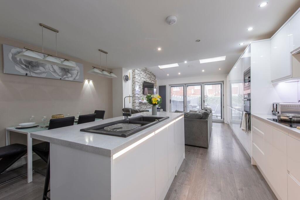 A sleek, modern open-plan living area featuring...