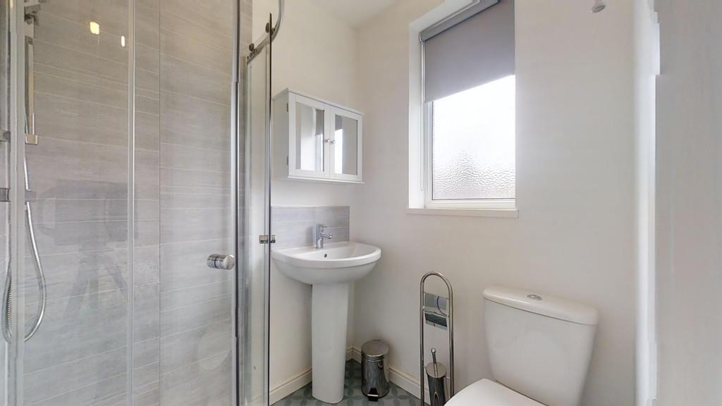 Bright and modern bathroom featuring a spacious...